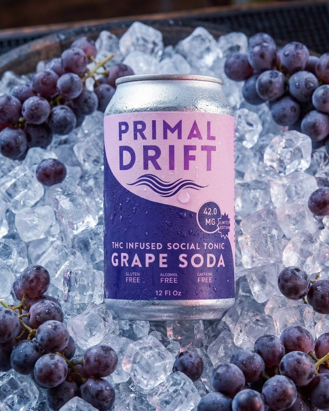 A limited-edition Grape Soda Social Tonic infused with 42.0 mg THC chills on ice among fresh grapes. The label spotlights it as gluten free, alcohol free, and caffeine freeβa perfect social tonic experience.