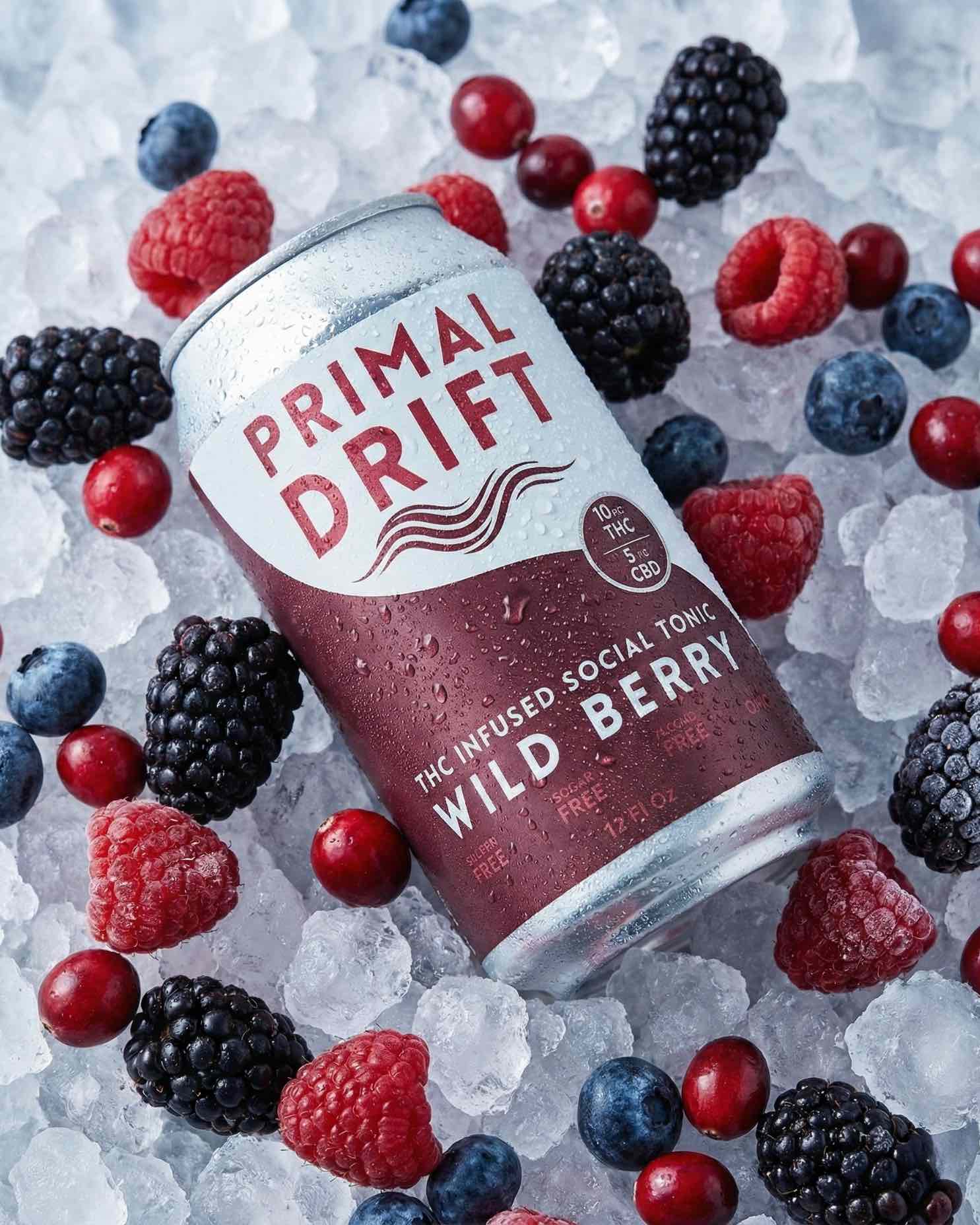 Primal Drift Wild Berry can surrounded by berries on ice