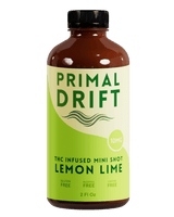 Bottle of Primal Drift THC-infused mini shot lemon lime flavor on a white background