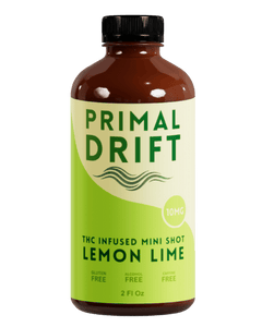 Bottle of Primal Drift THC-infused mini shot lemon lime flavor on a white background